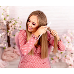 The Belle Backcomb displayed on a vanity with other hair styling tools