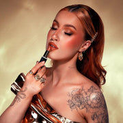 Model wearing a polished look using KASH True Satin Lipstick