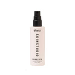 Skincare bottle with black spray nozzle on a white background