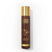 Brown spray tan bottle with gold cap on a white background