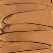 Close-up of the dropper releasing the shimmery bronze elixir
