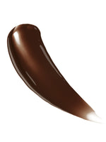 Close-up of the pump and tanning liquid texture in Dark tone