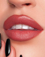Woman applying Bliss lipstick with smooth satin finish