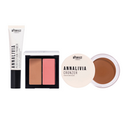 Makeup products including a tube, palette, and croner on a white background