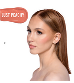 Woman with 'Just Peachy' blush on a white background