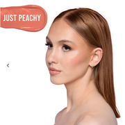 Woman with 'Just Peachy' blush on a white background
