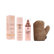 Set of self-tanning products including a box, bottle, mist spray, and mitt on a white background.