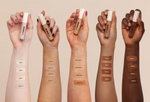 Five hands with different skin tones holding makeup products, showing color swatches on wrists.