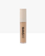 Cosmetic concealer stick with beige color on a white background