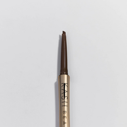 Brow pencil with gold casing and black text on a light gray background