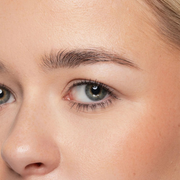 Close-up of a person's eye with clear skin