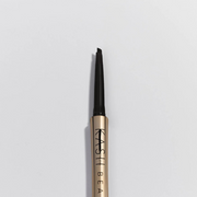 Eyebrow pencil with gold and black design on a light gray background