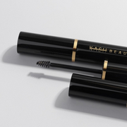 Black mascara with visible branding on a light gray background