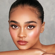 Model holding KASH Golden Hour highlighter compact