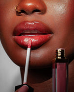 Model holding Rose Light lipgloss by KASH