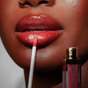 Model holding Rose Light lipgloss by KASH