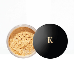 Open container of kash-loose-powder-honey-with-a-black-lid-featuring-a-gold-'K'-logo-on-a-white-background.