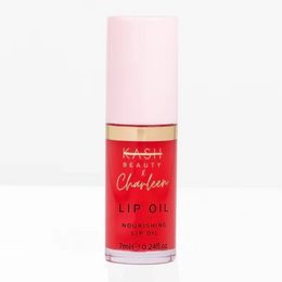 Lip oil bottle with pink cap and red body on a white background