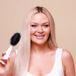 The Smoothing Brush placed on a bathroom counter in a styled setting