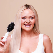 The Smoothing Brush placed on a bathroom counter in a styled setting