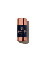 Bronze bar illuminating powder stick with rose gold cap on white background