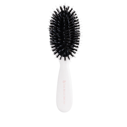 Front view of The Smoothing Brush with ergonomic handle and bristles